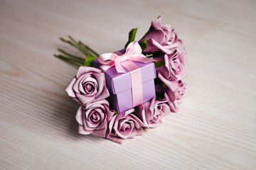 violet roses and gift box 
