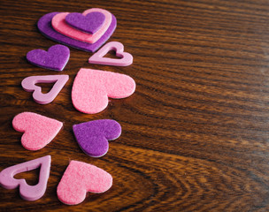 red and pink hearts on a wooden background