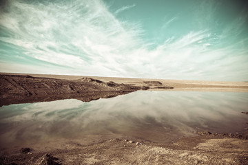 Iraqi landscape in winter with reflection of clouds on the surface of water