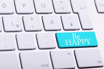 Elegant keyboard with BE HAPPY word in blue button