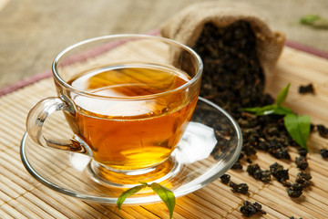 Tea and leaves tea on bamboo placemat