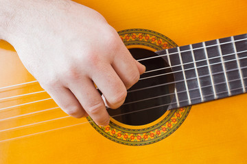Fototapeta premium Guitarist hand playing acoustic guitar
