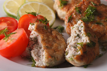 fried fish cake with herbs macro on a plate. horizontal
