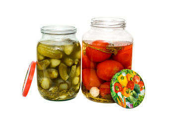 Fototapeta na wymiar canned cucumbers and tomatoes in glass jars on white