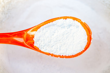 Pile of wheat flour with  spoon