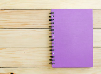 Purple Notebook on wooden table