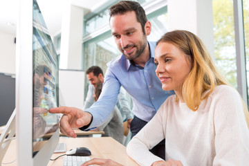 Young attractive people taking a training course with formator
