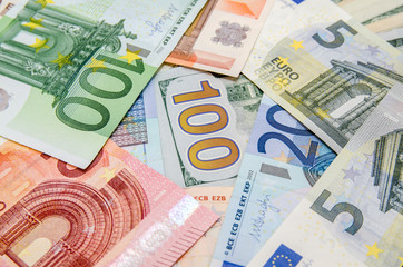 Pile of many different us dollars and euro