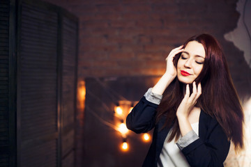 The girl with red hair  against the background lights