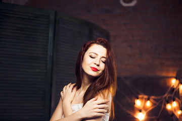The girl with red hair  against the background lights