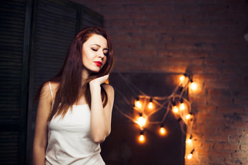 The girl with red hair  against the background lights