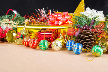 Christmas decorations, gifts, color balls, ribbons on a Veneer wood background.