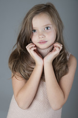 Portrait of little cute girl with long hair..