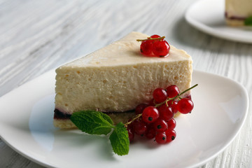 Delicious cheesecake with berries on table close up
