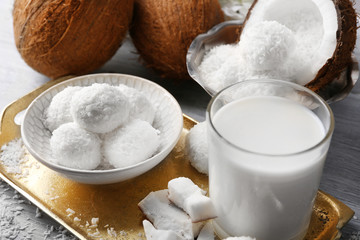 Homemade Candies in coconut flakes and fresh coconut on light background