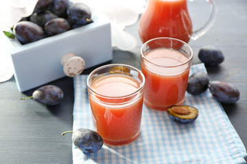 Plum Juice in a glasses with fresh fruits
