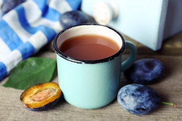Plum Juice in a mug with fresh fruits