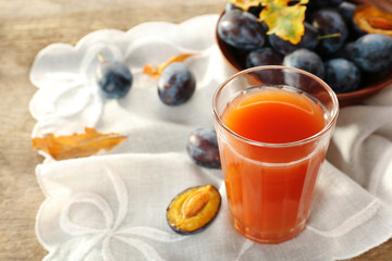 Plum Juice in a glass with fresh fruits