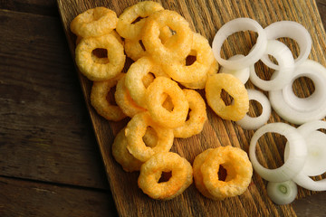 Chips rings with sauce and onion on cutting board