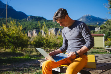 Freelancer working on computer over the mountain landscape