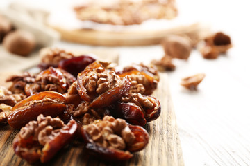 Walnut in date fruit on cutting board, close-up
