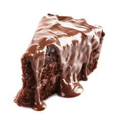 Chocolate poured on a piece of cake isolated on white