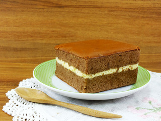 delicious soft cake chocolate flavor with cup of tea on wooden table