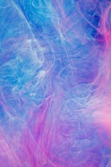 Blue pink clouds of ink in liquid