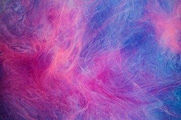Blue pink clouds of ink in liquid