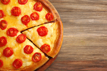 Pizza Margherita and removed slice on table, close-up