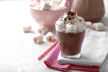 Glass of chocolate milk on table close-up