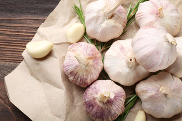 Composition of garlic and rosemary on the paper, close up