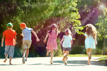 Happy active children running in park