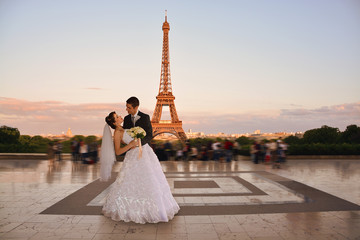 Wedding couple. Bride and groom in front of Eiffel Tower in Paris