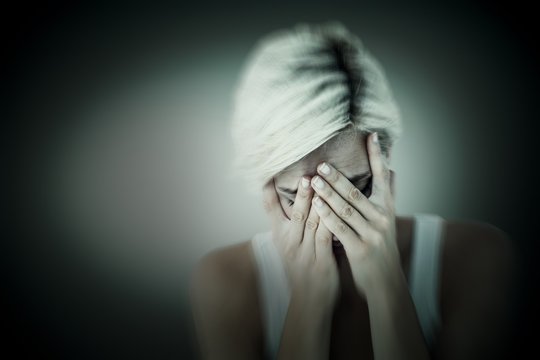 Composite Image Of Sad Blonde Woman Crying With Head On Hands 