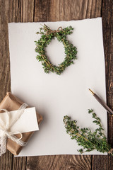 Christmas card with  wreath of rosemary and present