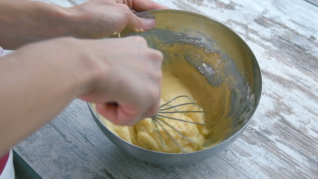 Preparation of cake. Corolla mixing dough. Close-up.