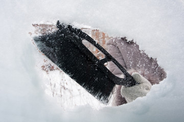 Naklejka premium hand with brush cleaning window of car