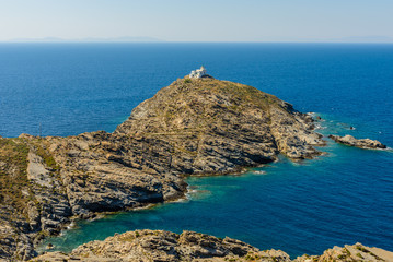 Lighthouse on a rocky coast, Paros island, Cyclades, Greece.