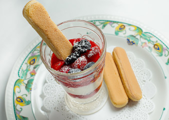  pudding with berries in glass and cookies