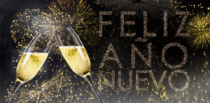 Champagne glasses clinking against glittering feliz ano nuevo