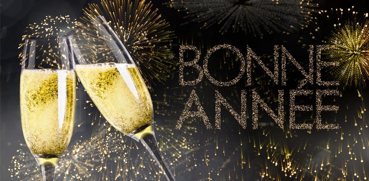 Champagne glasses clinking against glittering bonne annee