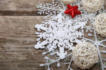 White snowflakes on a wooden background.
