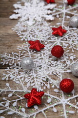White snowflakes on a wooden background.