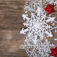 White snowflakes on a wooden background.