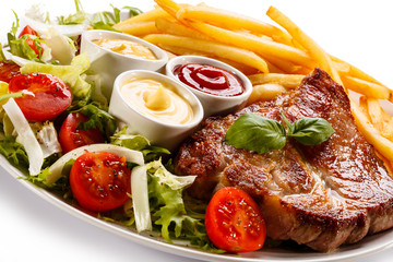 Grilled steak, French fries and vegetables