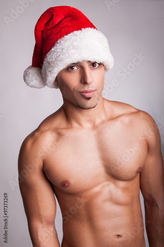 Beautiful Sexy Naked Fashion Model With New Year Hat And Sexy Muscular Body Looking At Beautiful Sexy Naked Fashion Model With New Year Hat And Sexy Muscular Body Looking At
