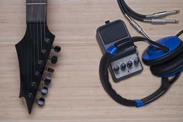electric guitar, headphones and distortion unit