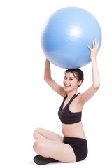 Young woman doing exercises with fitness ball.