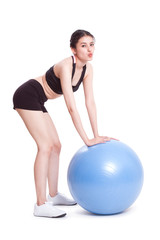 Fototapeta na wymiar Young woman doing exercises with fitness ball.